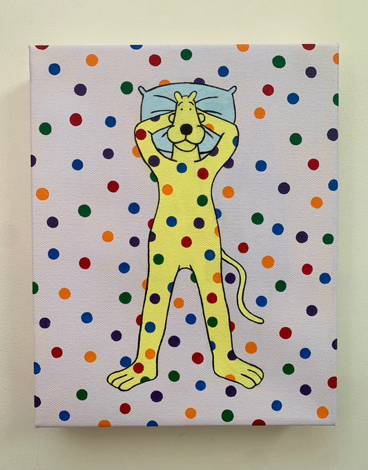 Canvas painting of a yellow cartoon leopard lying on the ground with his head on a pillow. Rainbow spots are all over him and the background