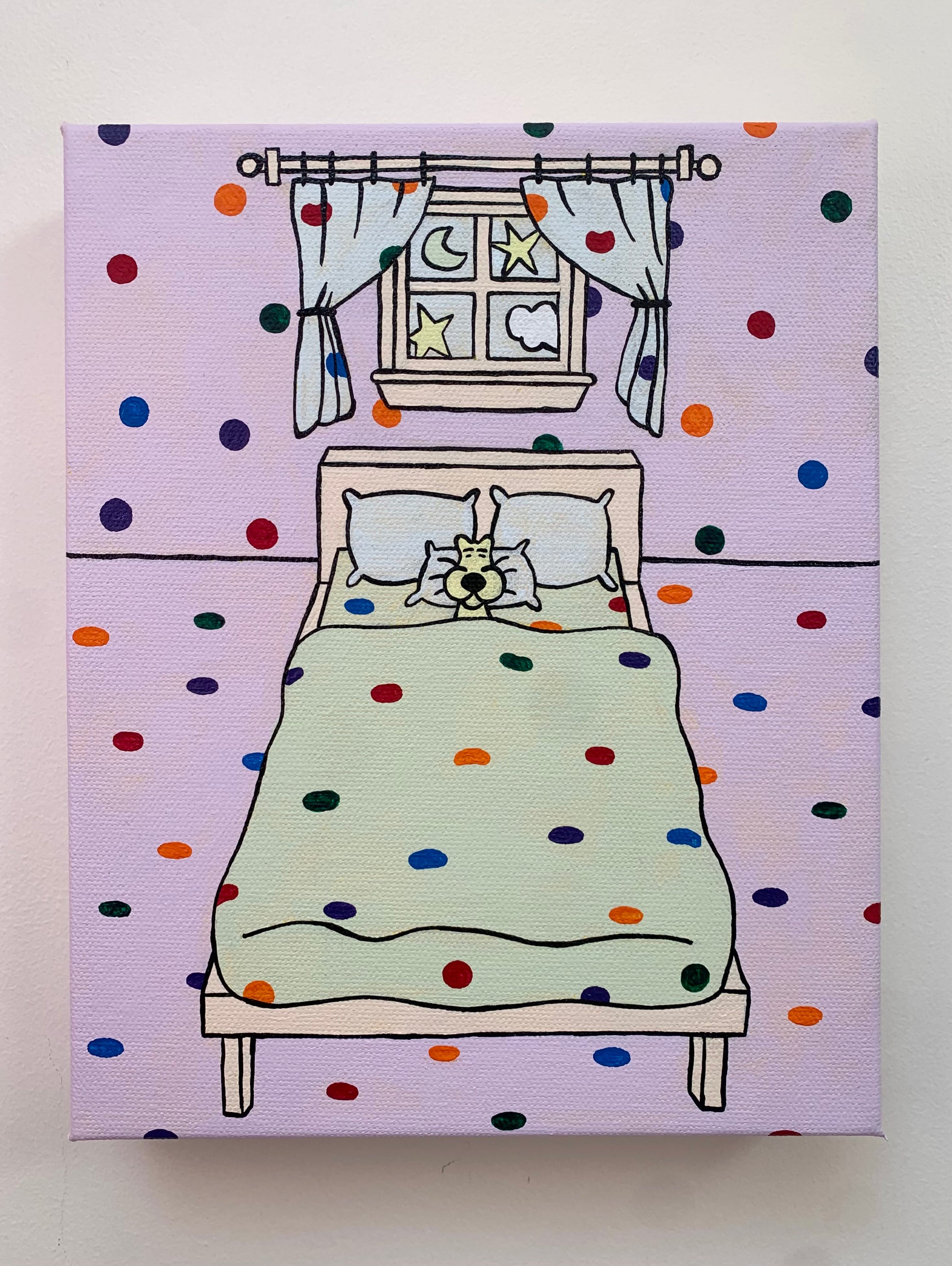 Canvas painting on a white wall of a cartoon bedroom with rainbow polka dot walls, bed, and window with curtains and a moon outside. Sleeping leopard in the bed. 